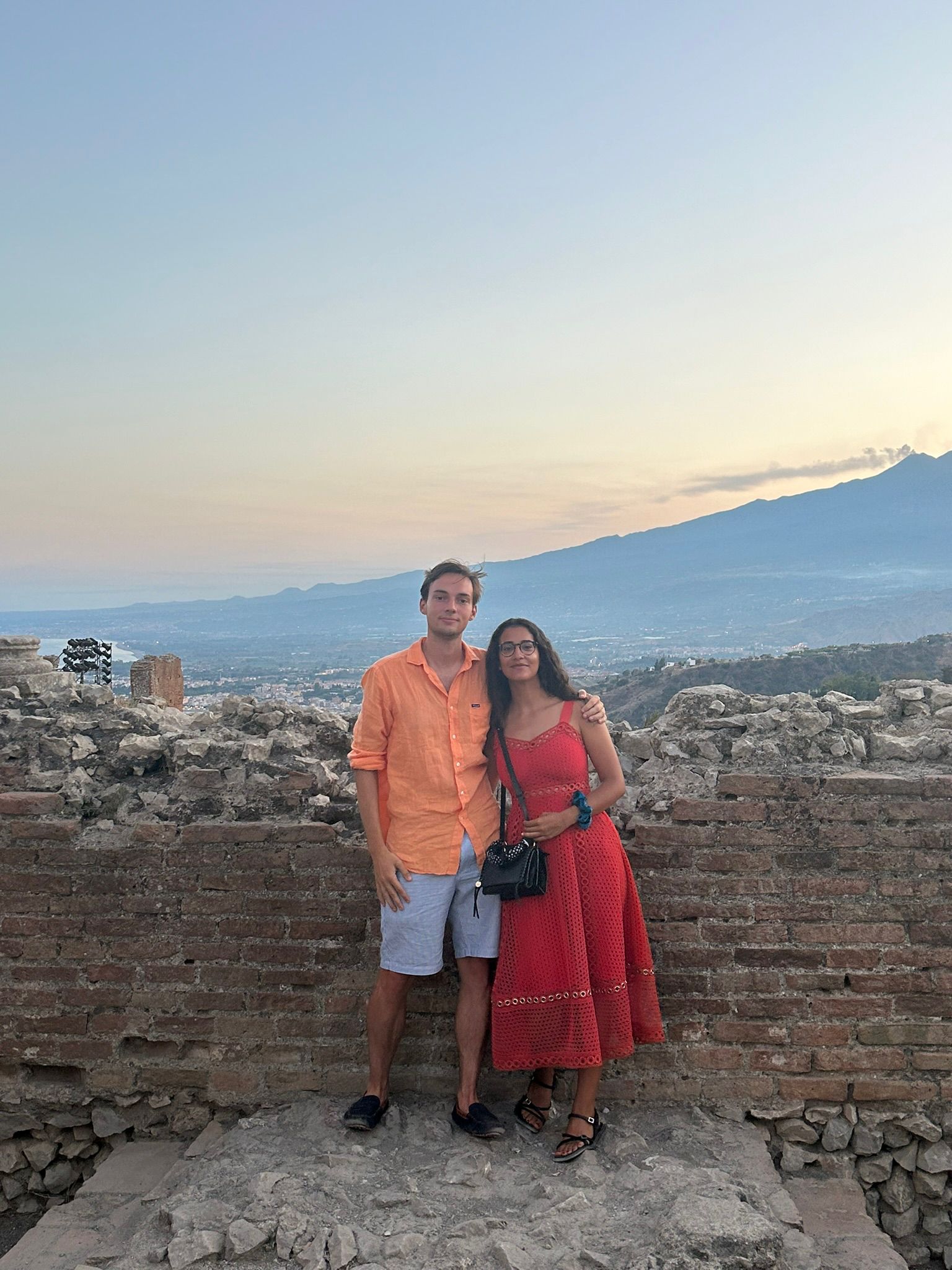 Wide landscape shot at sunset of rolling green hills.